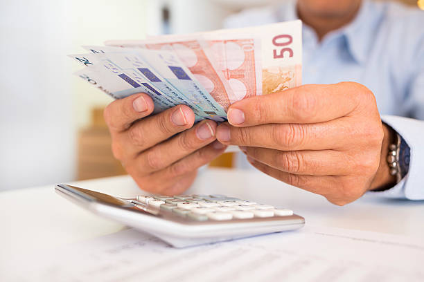 istock Financial advisor man holding money and doing his work 467194613