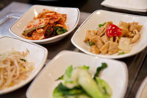 Korean barbecue dinner side dishes - kimchi and various kind of vegetables.
