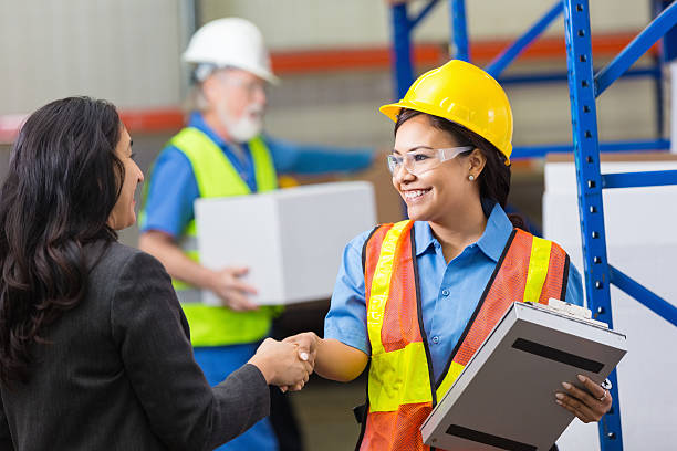 istock Female warehouse worker shaking hands with female supervisor 467196232