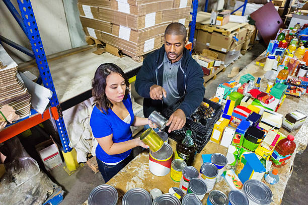 istock Volunteers sorting donations in large food bank distribution warehouse 467196234
