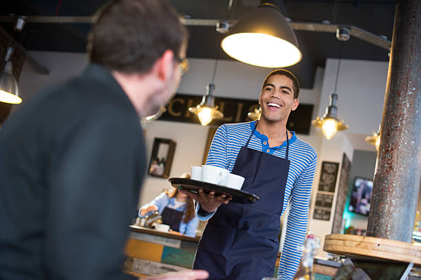 istock waiter brings coffee to customer in cafe 467197260