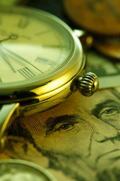 istock Time and Money. Clock in US dollars - Stock Image 467200716