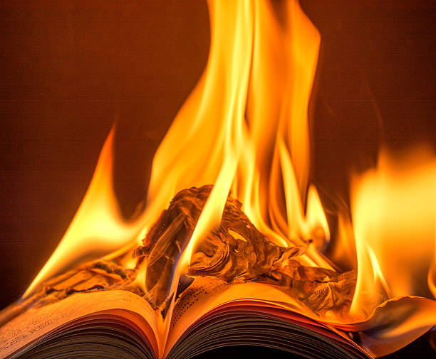 istock Burning book with brilliant flames and copy space- black background. 467201088