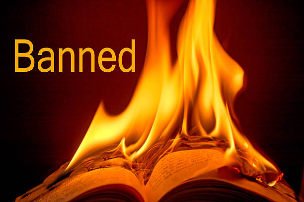 istock Burning book with the word Banned- black background. 467201420