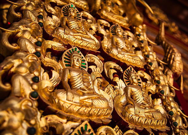 Chiang Rai, Thailand - May 2, 2013: Gold colored Buddhism ornament of the wall at the temple named Wat Ming Muang in Chiang Rai, Thailand.
