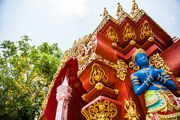 Chiang Rai, Thailand - May 2, 2013: Blue colored Buddha statue at gate of the temple named Wat Ming Muang in Chiang Rai, Thailand.