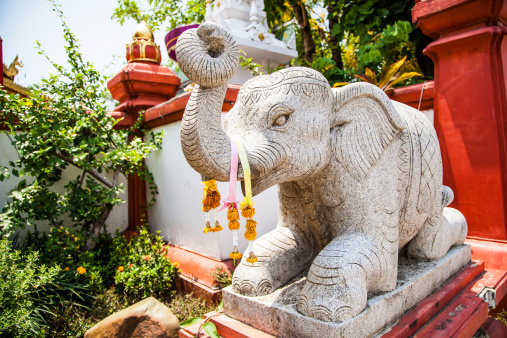 Chiang Rai, Thailand - May 2, 2013: Buddhism stone statue of the elephant in front of the temple named Wat Ming Muang in Chiang Rai, Thailand.