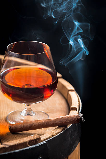istock Smoking cigar and wooden brandy barrel 467203117