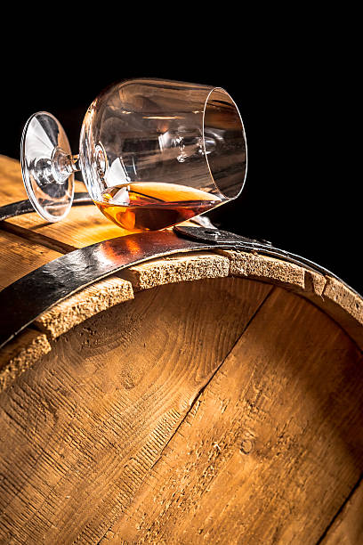 istock Cognac in glass on old vintage barrel 467203337