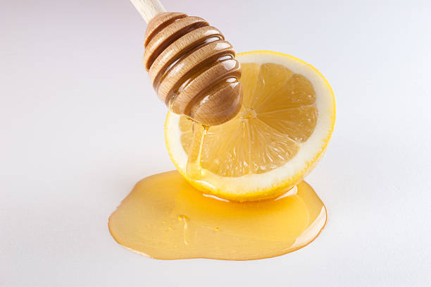 istock honey dripping on half of lemon isolated white 467205582