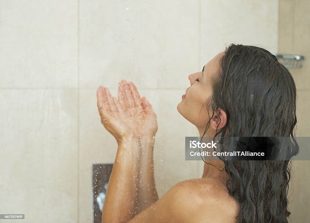 young woman washing in shower. rear view Young woman washing in shower. rear view Adult Stock Photo