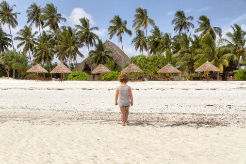 Children (Toddler) walking on the beach during low tide in Zanzibar