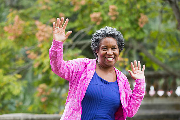 istock Senior African American woman with hands raised 467207932