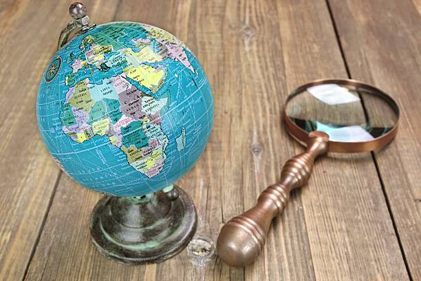 istock World Geographical Globe And Magnifier On The Wooden Table 467208068
