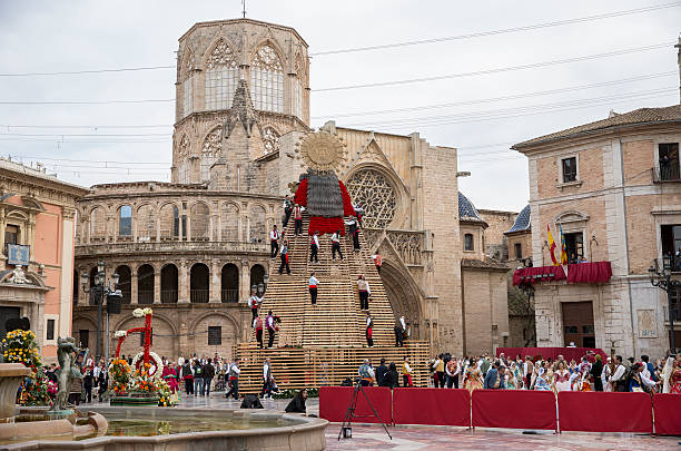 Valencia, Spain – March, 17, 2015: Flower offering to Virgin Mary in Fallas in the streets of Valencia, Spain. They dress the Virgin Mary with flowers in the Cathedral's square. 