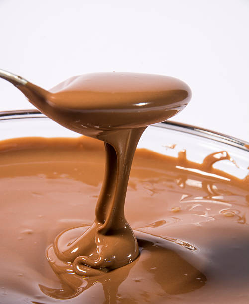 istock Glass bowl of melted milk chocolate 467209307