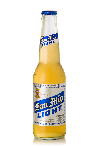 Bali, Indonesia - March 10, 2015: Studio shot of a the beer bottle San Miguel Light, isolated on white background with a clipping path.