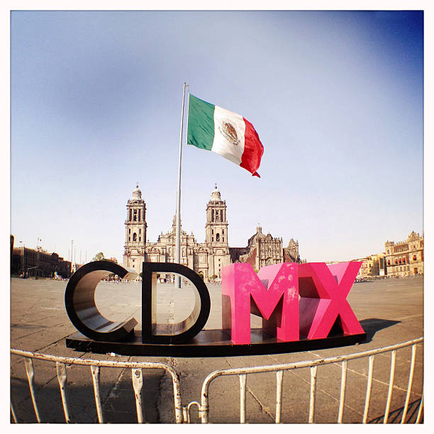 Mexico City, Mexico - February 10, 2015: The ne logo of Mexico City, CDMX (Ciudad de Mexico) on the main square, the Zocalo, in front of a huge Mexican flag and the main Cathedral.