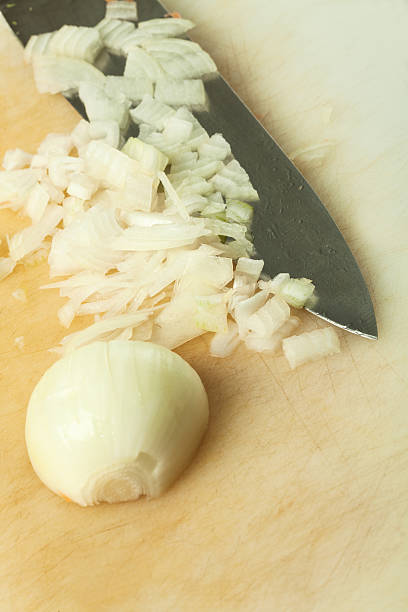 istock Close up of onion and kitchen knife on chopping board 467216459