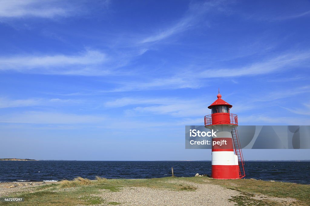Lighthouse in red and white at Grisetaa Odde Lighthouse Grisetaa Odde by Limfjorden in the north of Jutland, Denmark Bay of Water Stock Photo