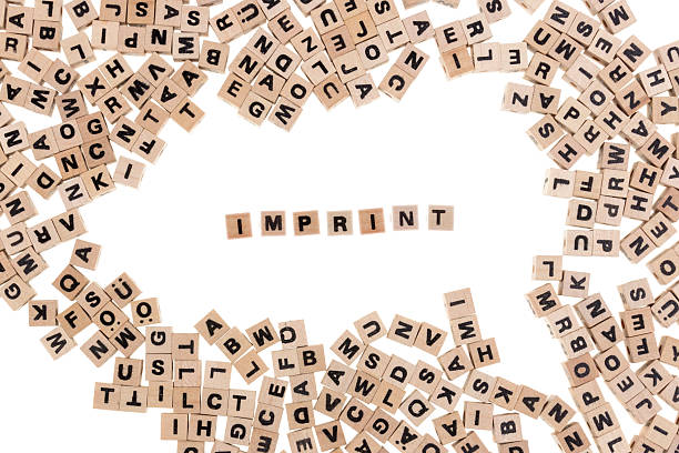 imprint framed by small wooden cubes with letters isolated on white background