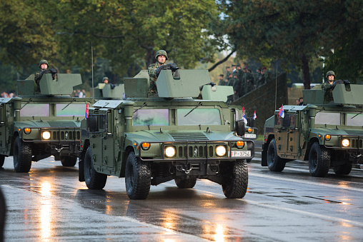 Belgrade,Serbia - October 16, 2014: Serbian military  in Hummer whicle equipped with automated granade launcher, participating in military parade held in Belgrade. Serbian military troops participating in the military parade in Belgrade, Serbia. The ceremony marks the 70th anniversary of the liberation of Serbian capital from Nazi German occupation. Russian president Vladimir putin attendees parade.