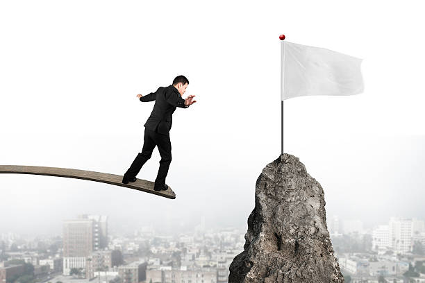 istock Businessman balancing on wooden board with blank white flag 467224700