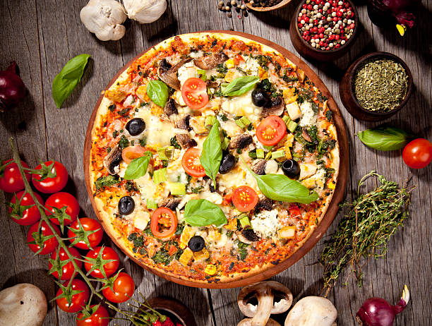 istock Delicious fresh pizza served on wooden table 467225093