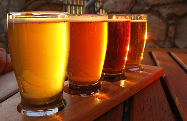 Colorful beer flight Beer flight with yellow, orange, and brown hues.  Different flavors and types of beers. microbrewery photos stock pictures, royalty-free photos & images