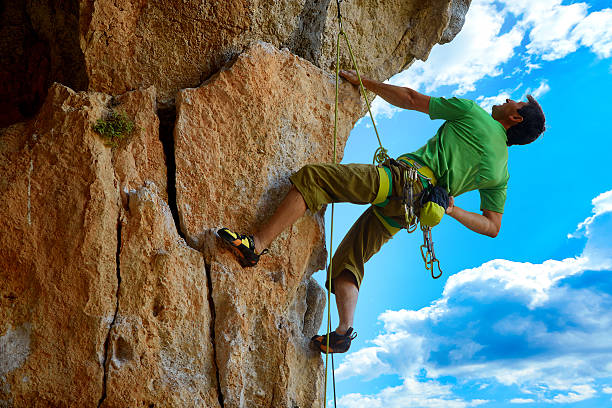istock Rock climber climbing up a cliff 467228318