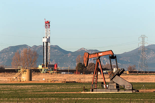 istock Oil derrick with fracking drill rig and Rocky Mountains Colorado 467228550