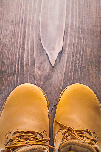 close up view on working boots vintage wooden board with copyspace 