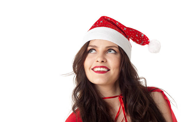 istock smiling santa girl looking on copyspace - isolated over white 467231836