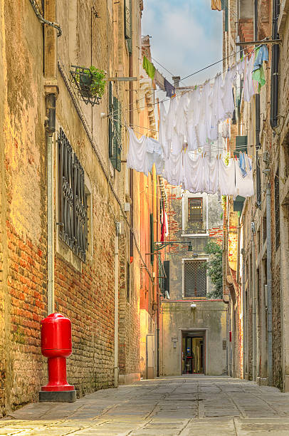 Clothes hanging out to dry between old houses in Venice stock photo