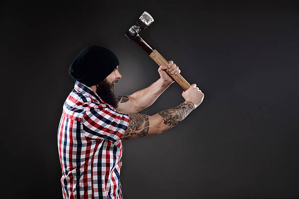 istock Furious lumberjack man swinging his axe 467232720