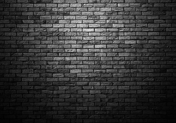 istock dimly lit old brick gray wall with ligth vignette 467233088