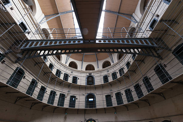 Hallways and metal bars of an empty prison stock photo