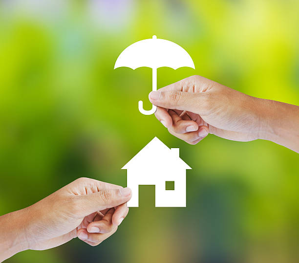 istock Two hands holding paper home and paper umbrella 467236683