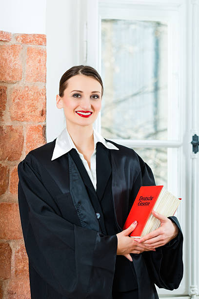 istock Lawyer in office reading law book 467239481