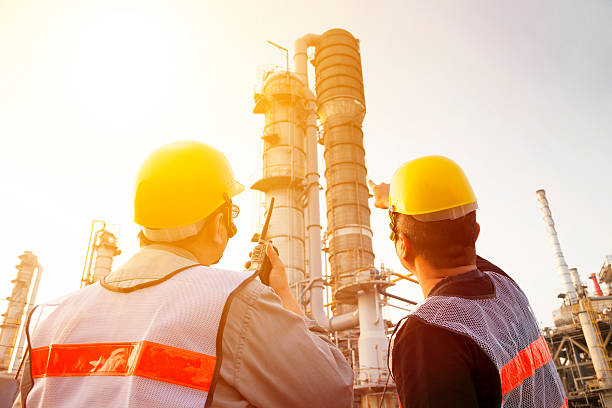 istock refinery workers discussion and pointing for inspection 467239786