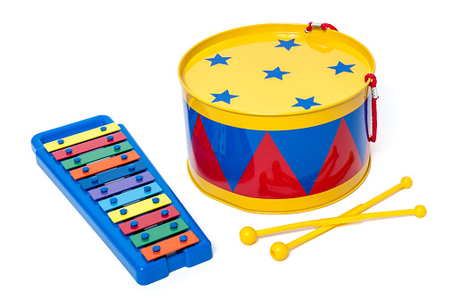 Colorful toy metal drum and xylophone in bright colors for preschool isolated on white