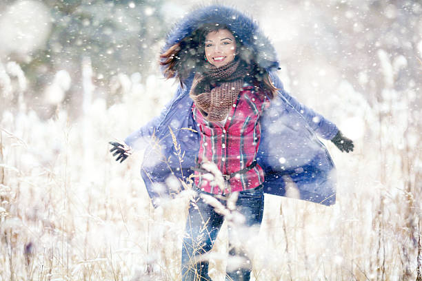 istock Girl having fun and jumping in the snow 467242844
