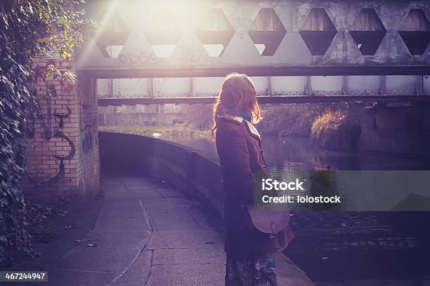 Young Woman By Canal At Sunset Stock Photo - Download Image Now - Loneliness, Street, Walking