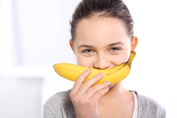 istock Girl with banana 467248181