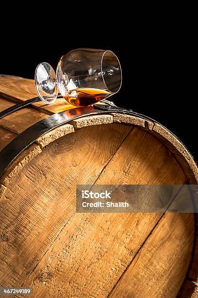 Glass Of Cognac On The Old Wooden Barrel Stock Photo - Download Image Now - Alcohol - Drink, Barrel, Black Color