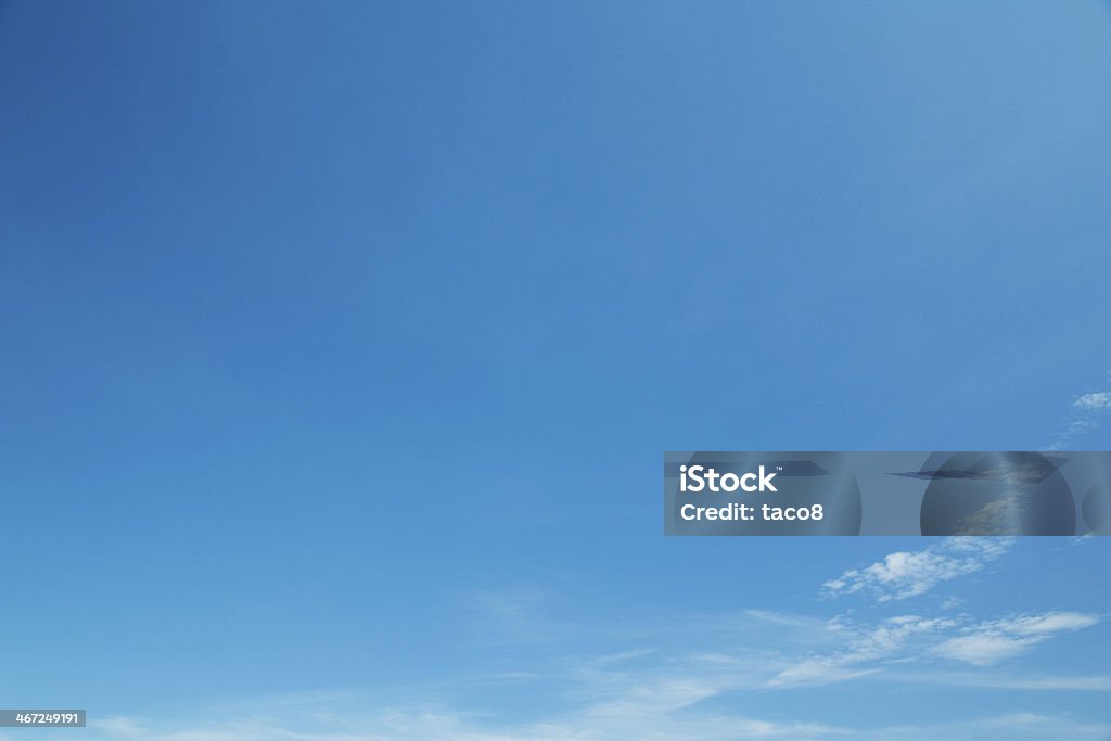 Background of a clear blue sky with a few wispy white clouds sky Backgrounds Stock Photo