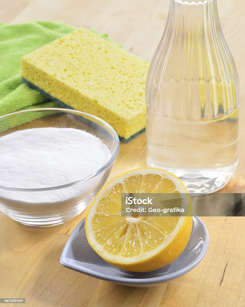 Natural cleaners. Vinegar, baking soda, salt and lemon. Eco-friendly natural cleaners. Vinegar, baking soda, salt, lemon and cloth on wooden table. Homemade green cleaning. Cleaning Stock Photo