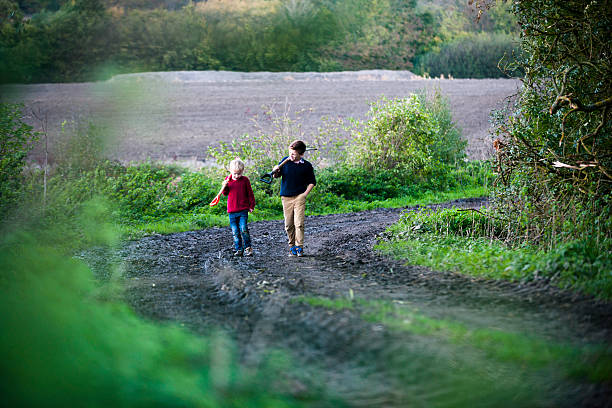 istock A walk down a country road, shovels in hand.  467249995