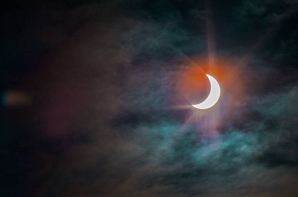 Solar Eclipse 2015 with clouds and charming glare stock photo
