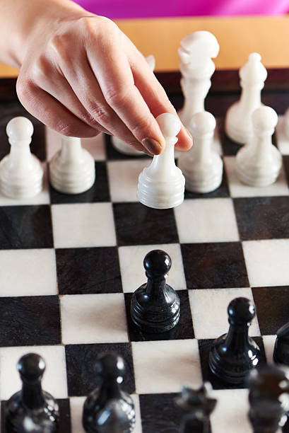 istock Hand with white pawn over chessboard 467252260